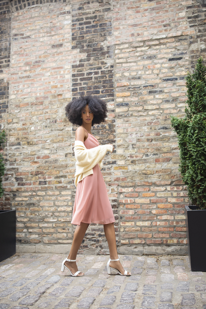 girl in short pink bridesmaid dress with cardigan