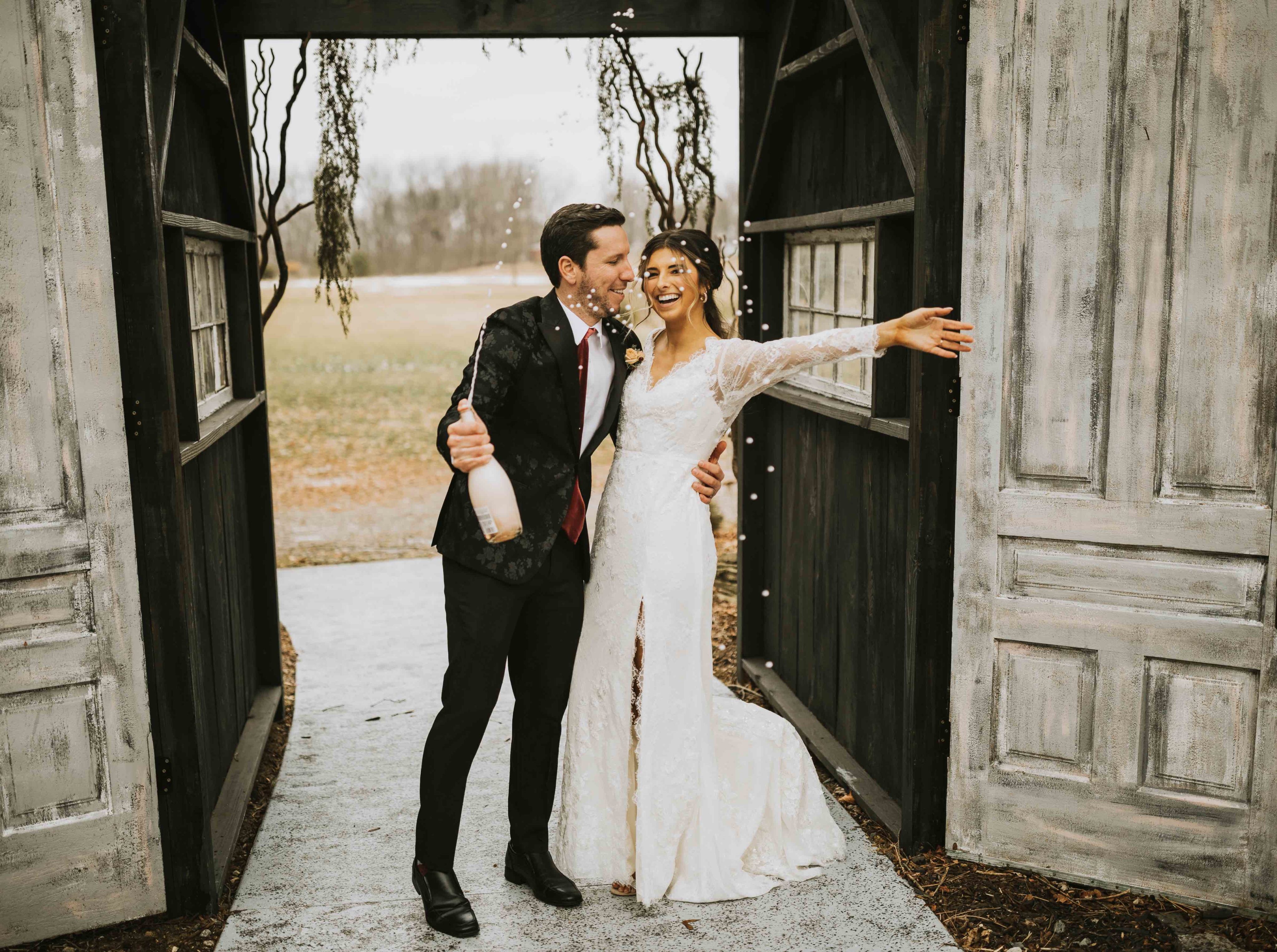 Bride and groom popping champagne