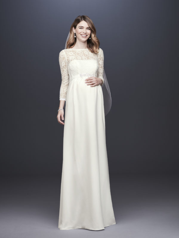 Pregnant bride in an ivory lace dress and veil